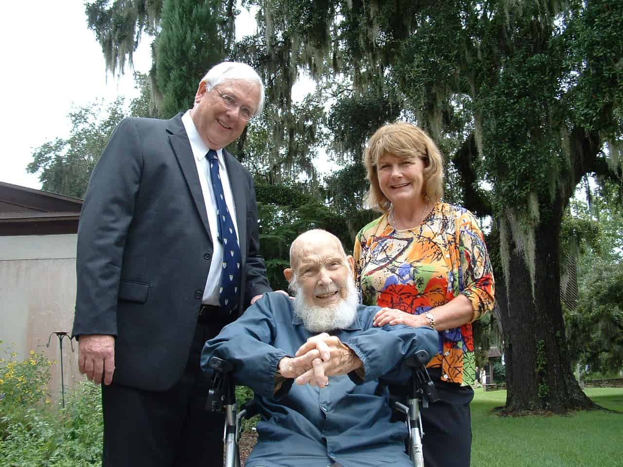 Fr. Christian with his nephew, Dan Stacey and Dan’s wife Eve at Fr. Christian’s 100th birthday celebration.